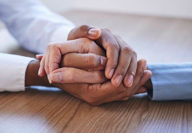 Empathetic person holding someone's hand