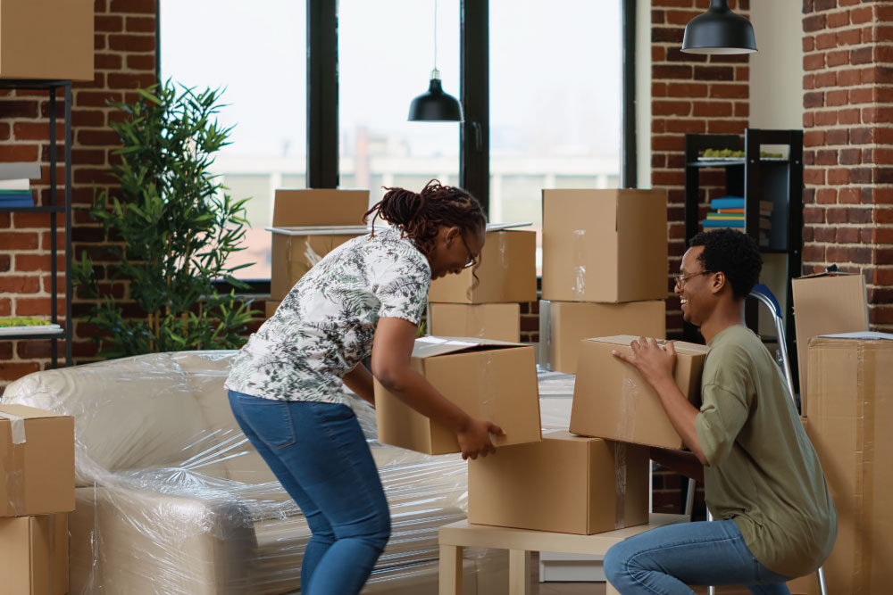 Tips for Optimising Engagement Throughout Your Tenants Journey - Image of two people packing boxes for a move